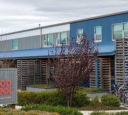 A building labeled "SLO Food Bank" with bikes outside.